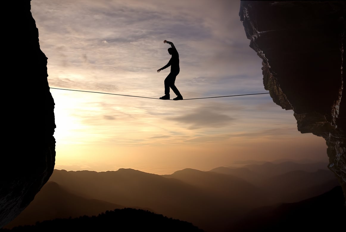 Man balancing on the rope concept of risk taking